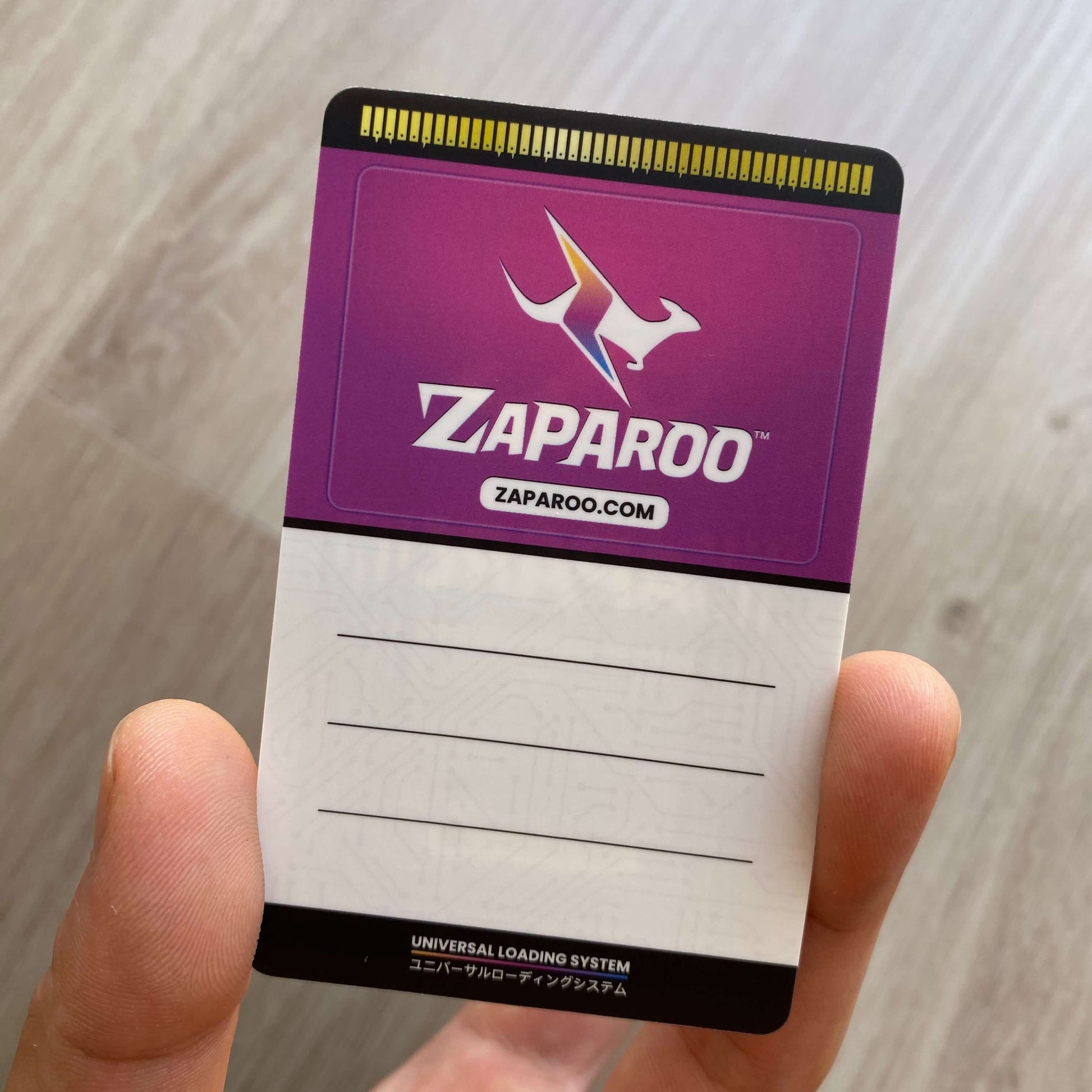 Funtastic Atomic card with Zaparoo logo held by a hand