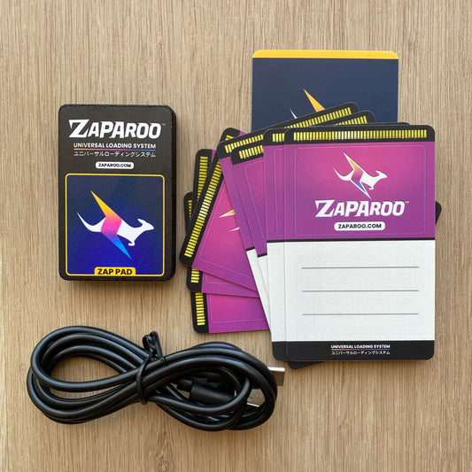 Black Zap Pad with stack of Zaparoo Funtastic Watermelon cards and USB cable