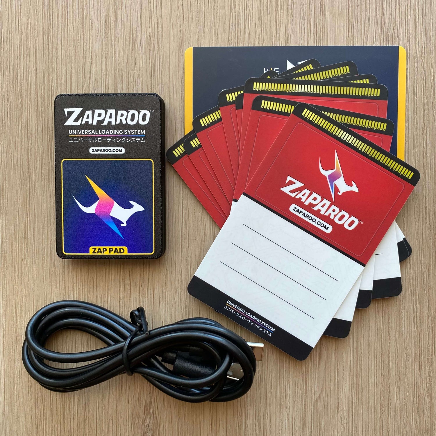 Black Zap pad, stack of Funtastic Watermelon cards and USB cable