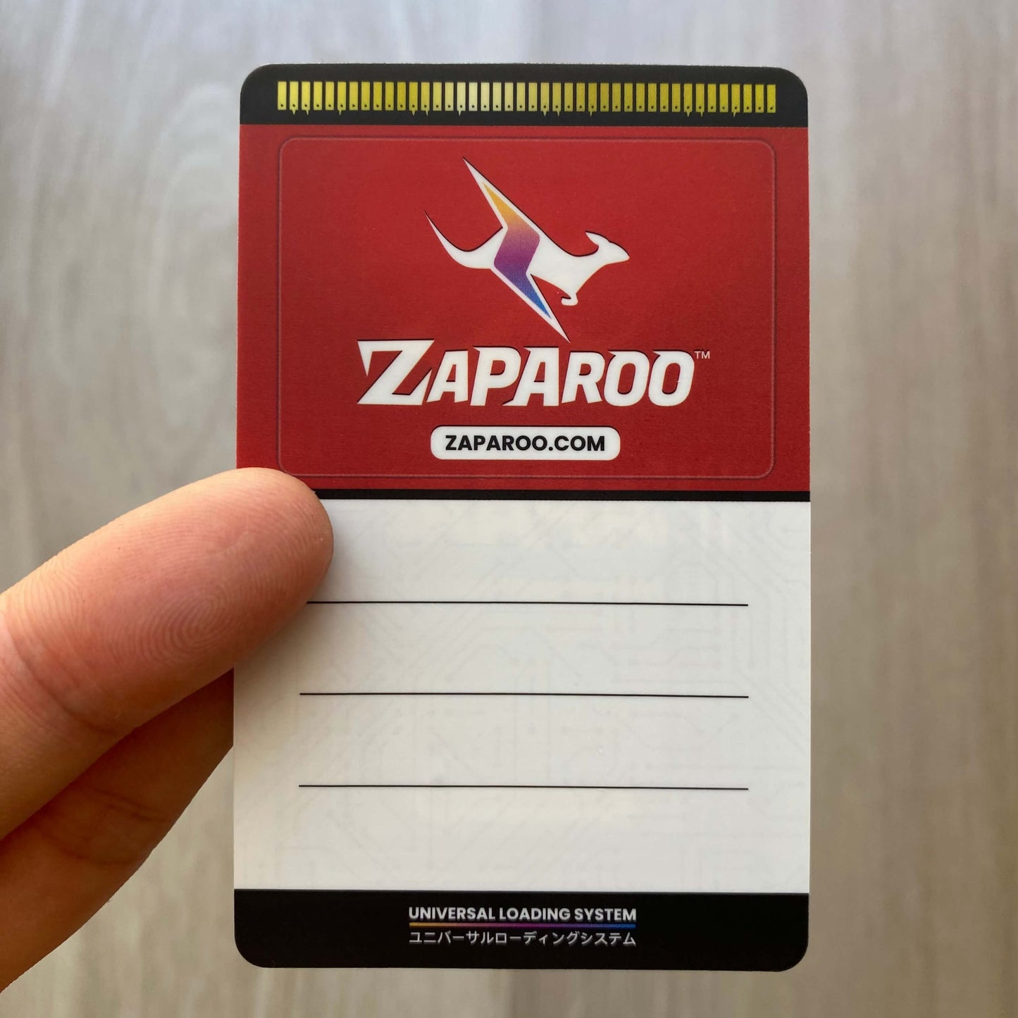 Funtastic Watermelon card with Zaparoo logo held by a hand on a light background